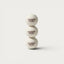 Three Maison Pupa cream felt tennis balls stacked vertically, each featuring a wine-toned brand wordmark.
